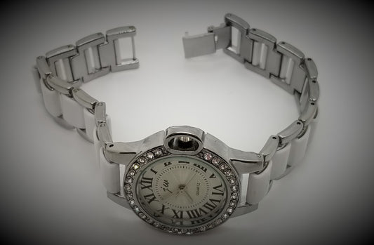 Silver base metal watch with rhinestones around crystal and white in center of strap